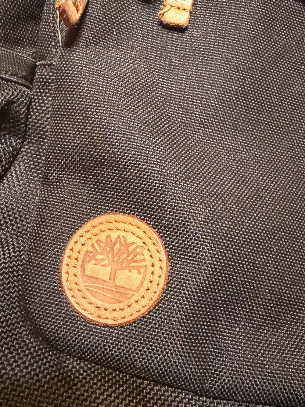 Timberland Black Sling Backpack with Brown Leather Accents
